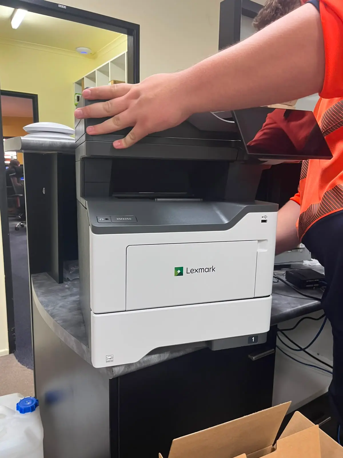 Lexmark XM3350 MFP configured on the bench before delivery.
