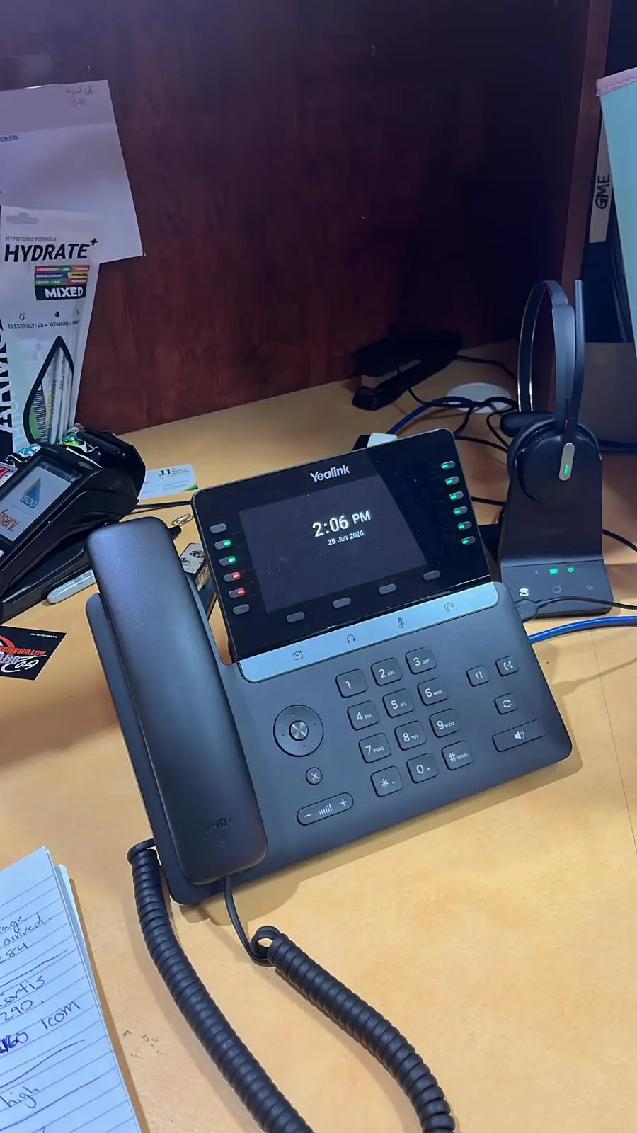Yealink IP handset paired with a wireless headset.